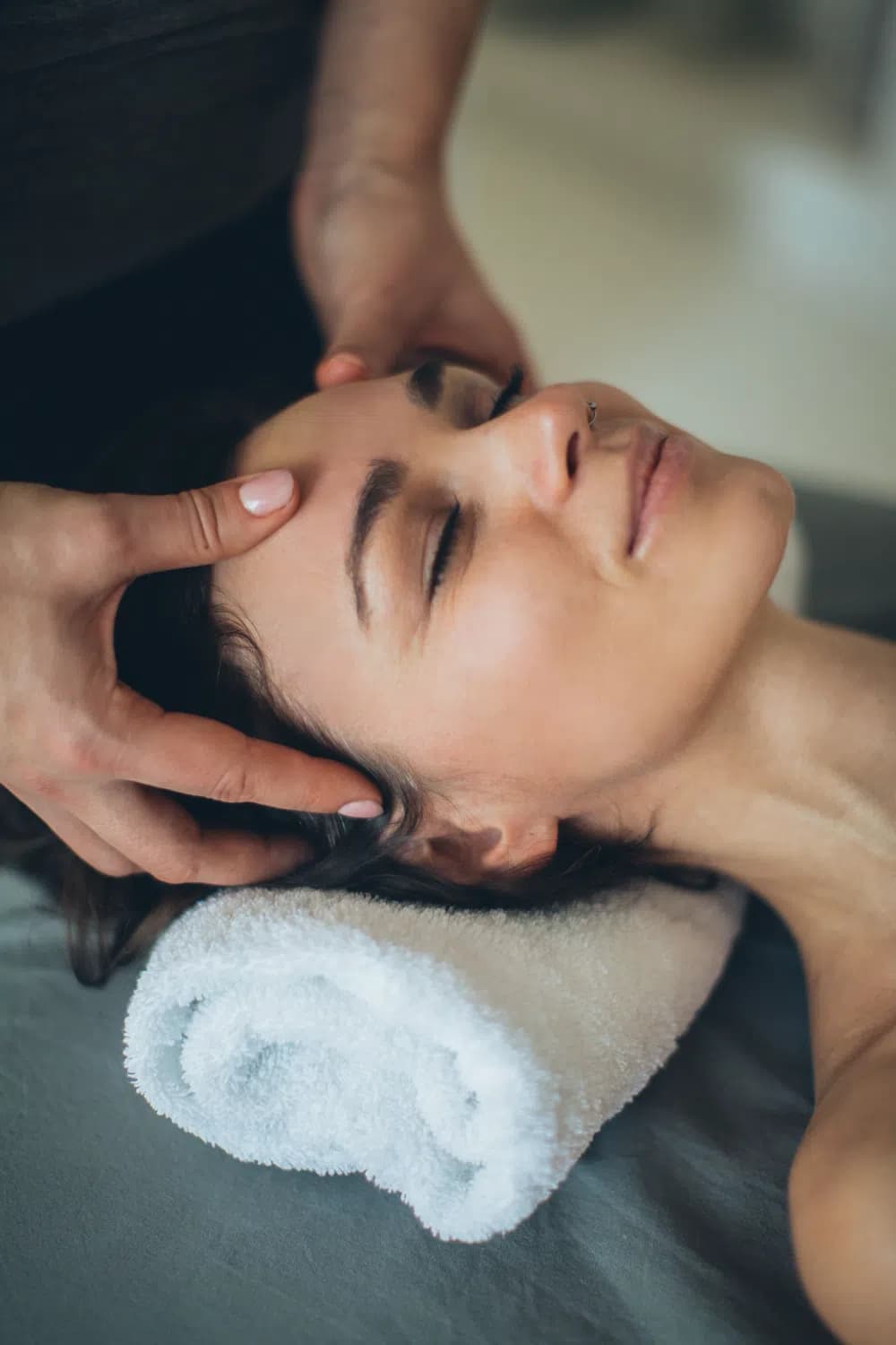 Client relaxing with eyes closed during an Indian head massage